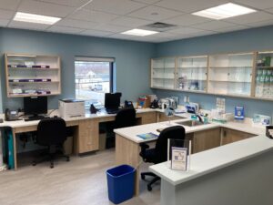 Small patient waiting area with chairs and Princeton Eye Group wall sign in the Somerset office